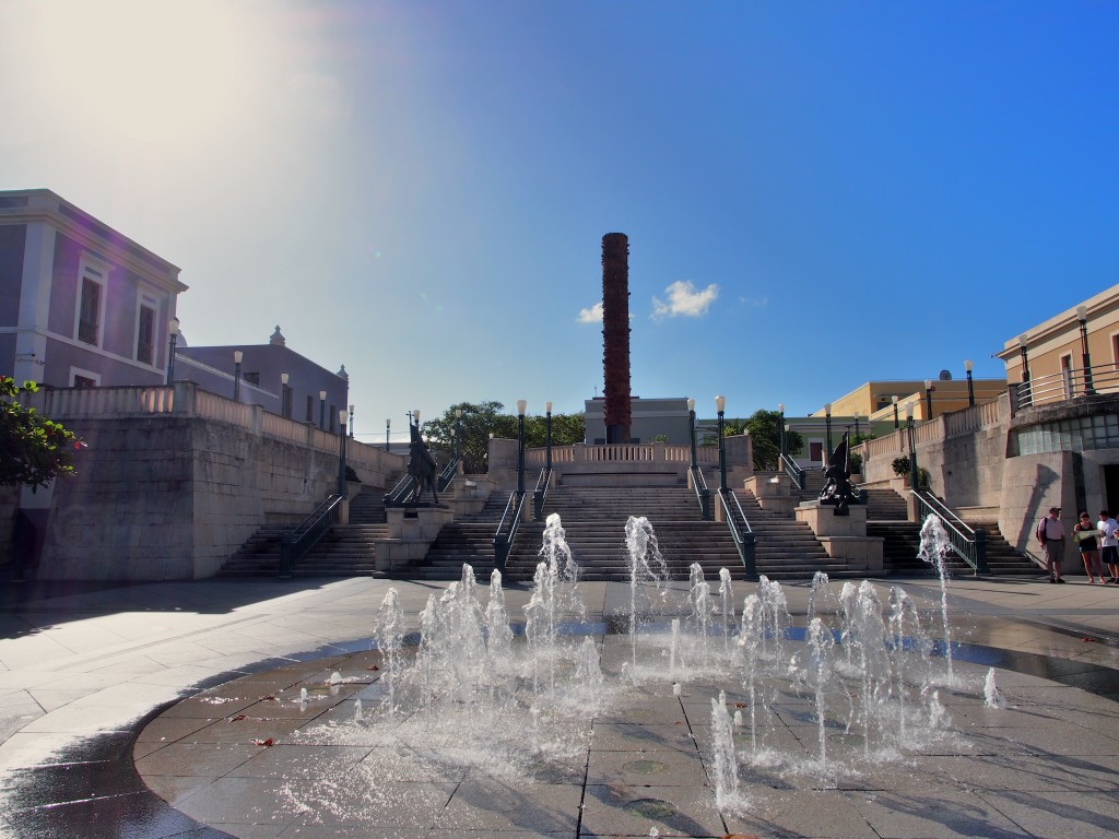 Fountain with a totem pole in the background.