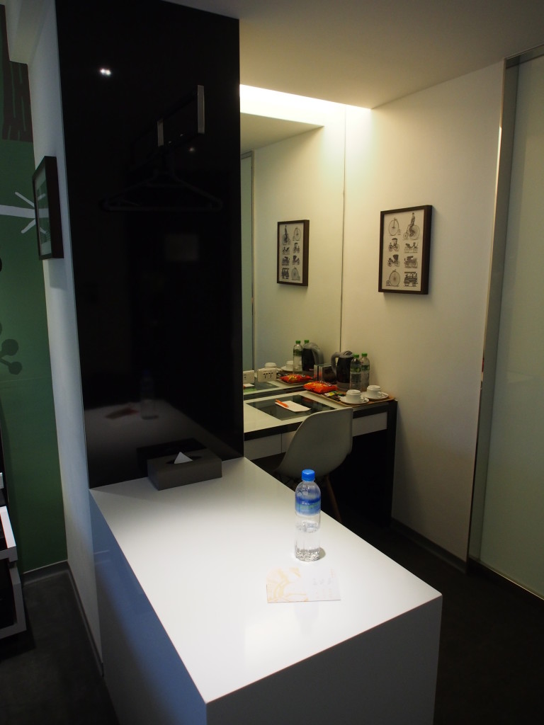 Dressing table in a corner with open style cabinet.