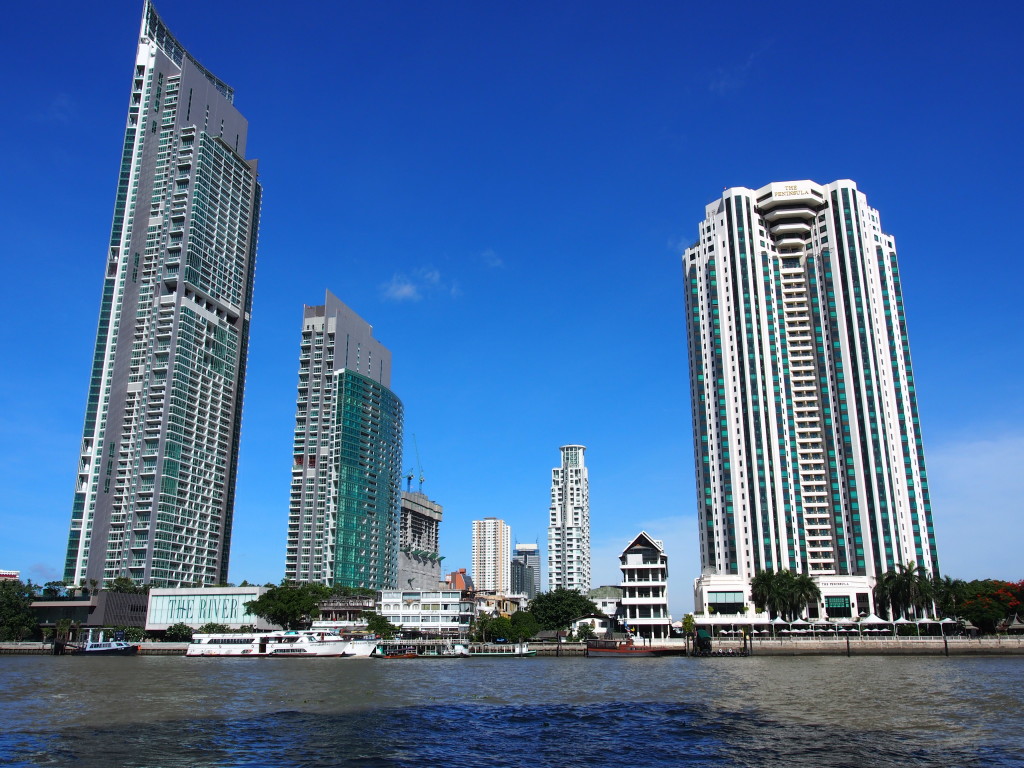 Tall buildings lining the other bank of the river.