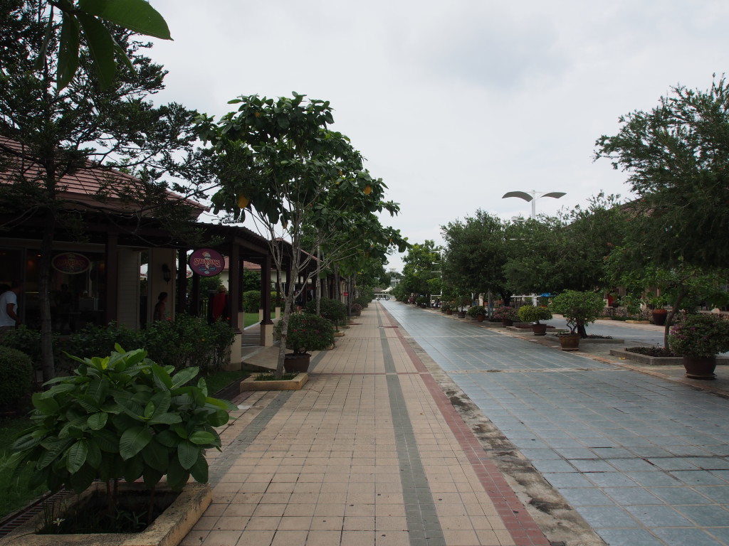 Long walk to the gates flanked by outlet style layout.