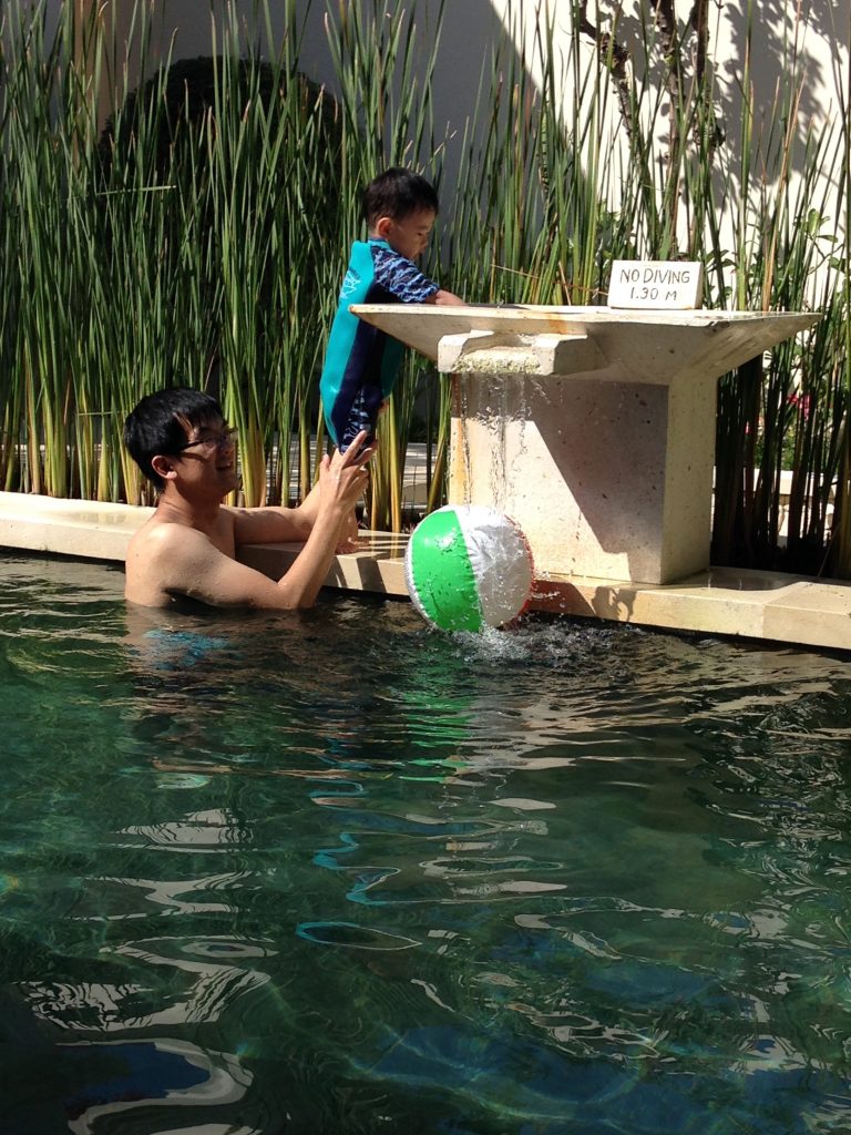 Father and son at the villa pool.